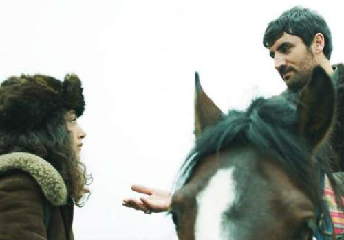With the bridge to the town bombed out by Turkey, seeking to limit the movement of Kurdish fighters in the area, Govend, clad in her evocative colbacco fur hat, is forced to accept a life on horseback from Baran, an act fraught with all manner of social implications which are later used against them both (image via SBS Australia)