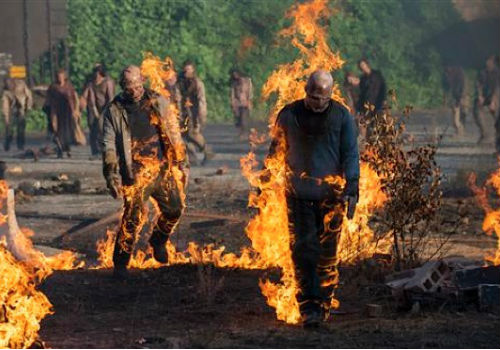 Finger-lickin' good BBQ'd zombies anyone? Set on fire by Carol's near-miraculous fireworks-ignited propane tank bomb, the walkers just kept on going, making short work of most of the once smugly cruel inhabitants of Terminus (image via Paste Magazine (c) AMC)
