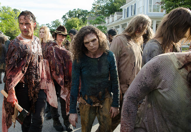 In a sign that the living and the dead aren't that far apart after all, both Rick Grimes and Fashionablt-Attired Zombie Lady both adopt the "Did I leave the iron on?" look at exactly the same time (image courtesy AMC)