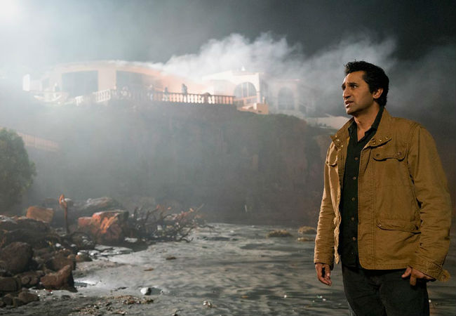 Curtis stands on the beach below Strand's mansion, LA burning above and beyond him ... and no, neither John Lee Hooker nor Ladyhawke really wrote a song about this (image courtesy AMC)